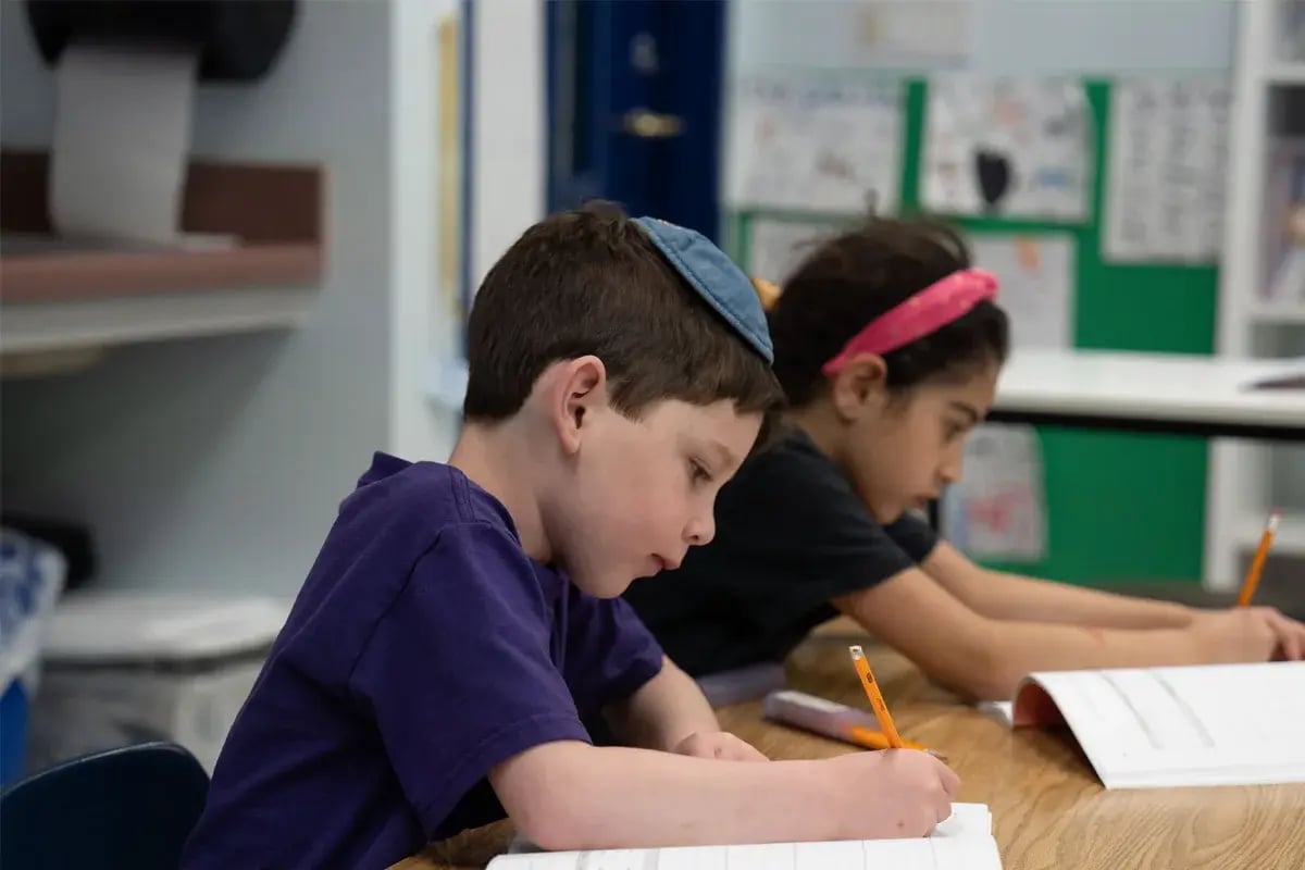 Jewish students working together in a classroom.