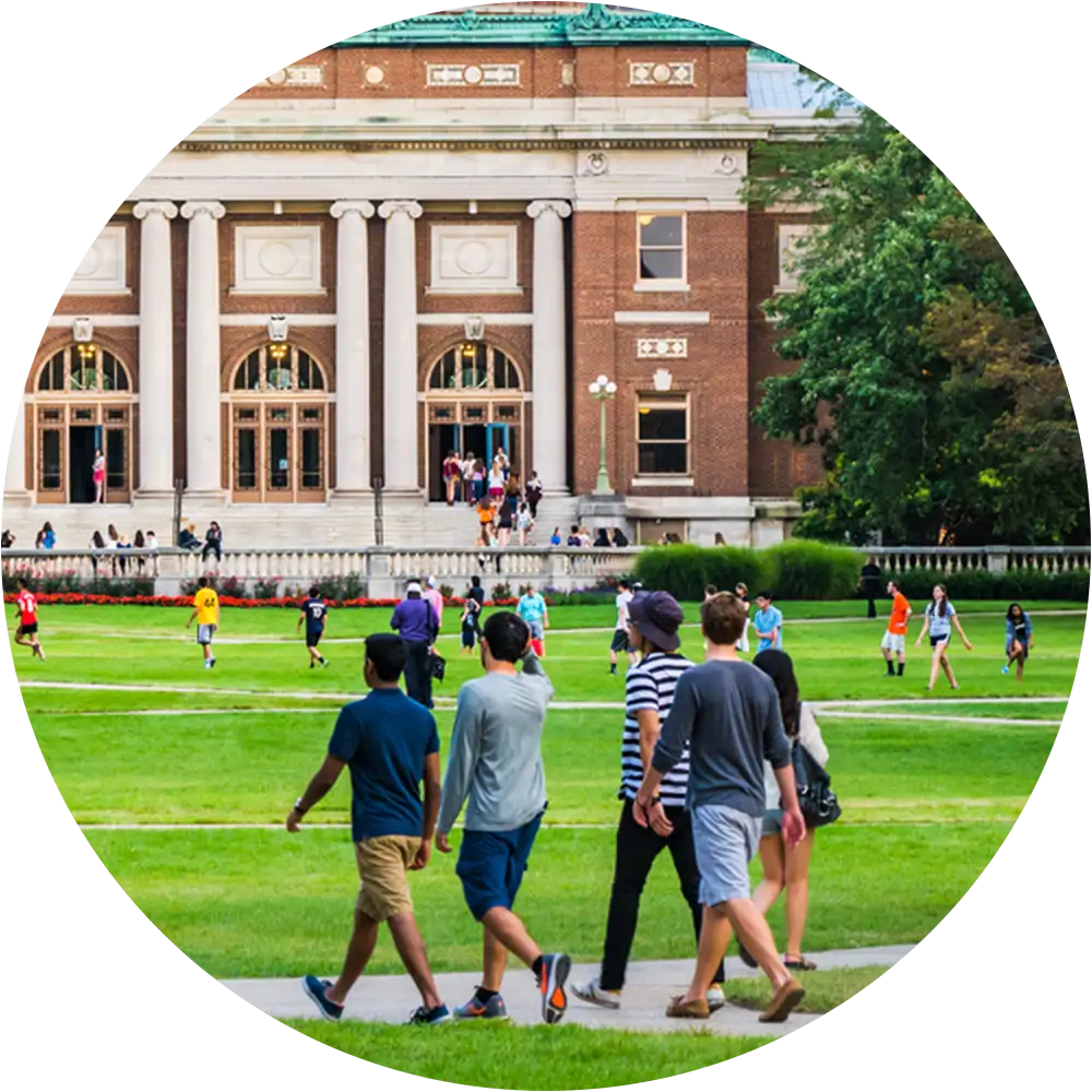 Students gathered across a college quad in Greater Boston, representing campus community life and shared environment
